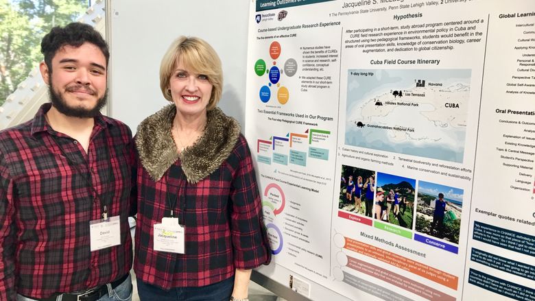 two people in front of poster
