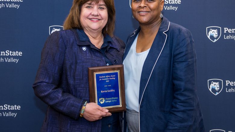 woman getting an award from another woman