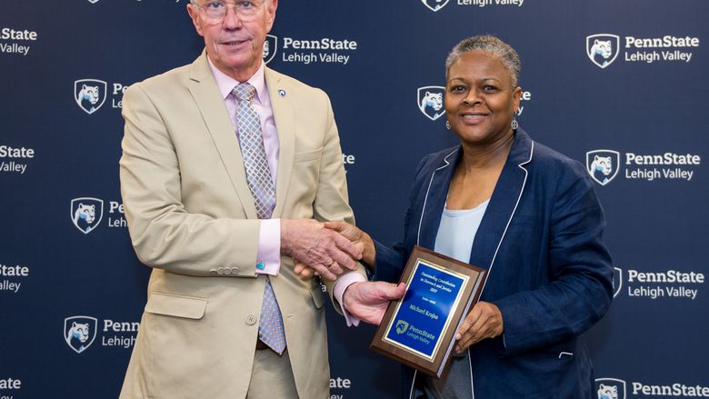 man accepting award from woman