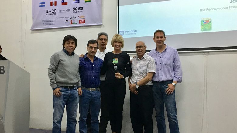 Dr. Jacqueline McLaughlin in the center with people from Bolivia at a presentation