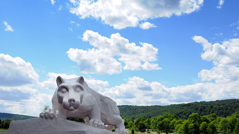 Penn Statte Lehigh Valley Lion Shrine statue with mountain and blue sky behind it.