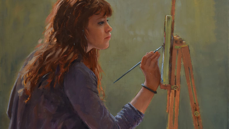 profile of woman painting on an easel with a paintbrush