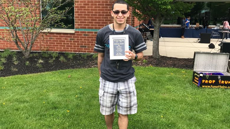 male student with award