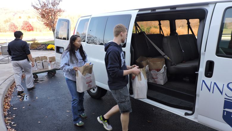 Students load the van with food donations
