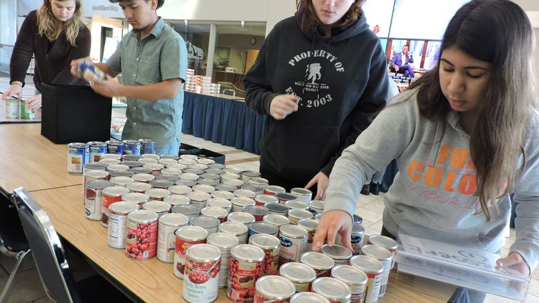 Students fill bags of food