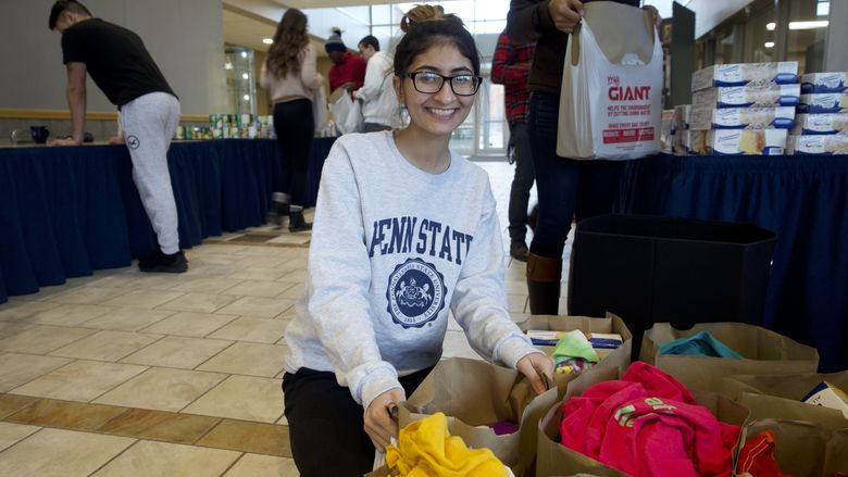 Student organizing bags of donated items