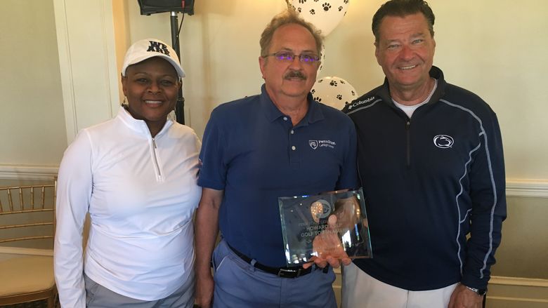 three people with an award