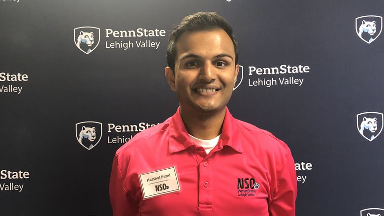 Young man standing in front of Penn State Lehigh Valley backdrop