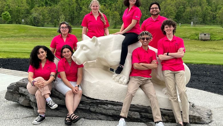NSO student leaders standing around the Lion Shrine