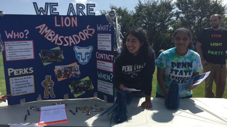 Two students staffing the Lion Ambassadors table