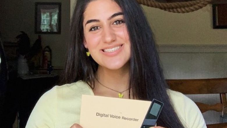Hanna holding a digital voice recorder