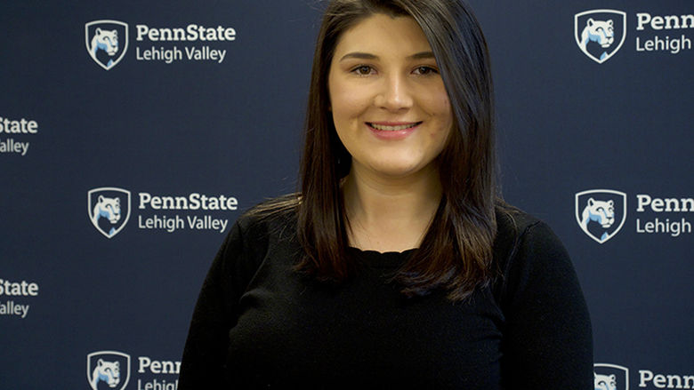 student standing in front of Penn State Lehigh Valley backdrop