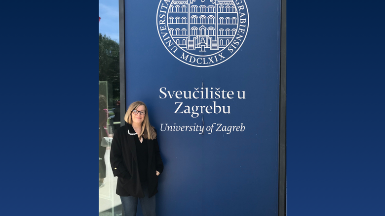 a person standing in front of a banner 