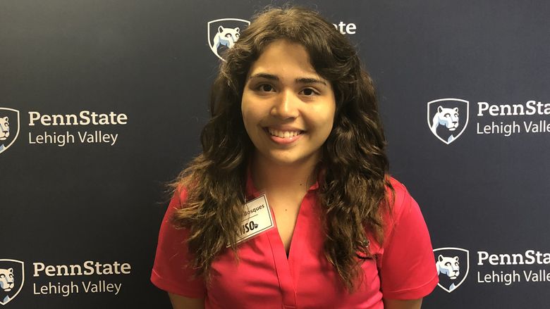 Young woman standing in front of Penn State Lehigh Valley backdrop