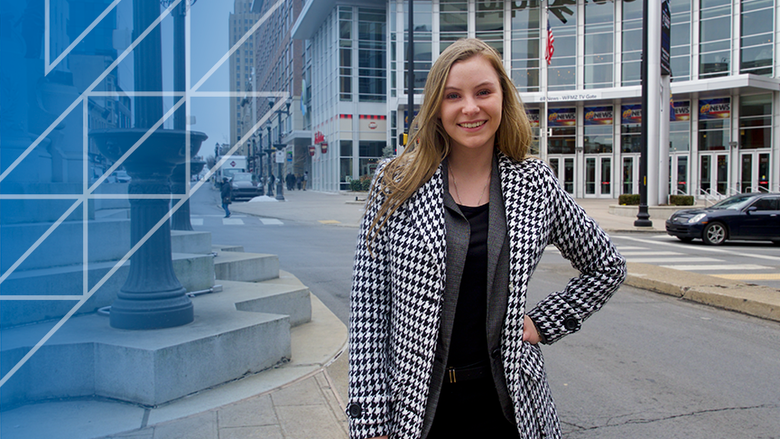 woman standing in city, smiling 