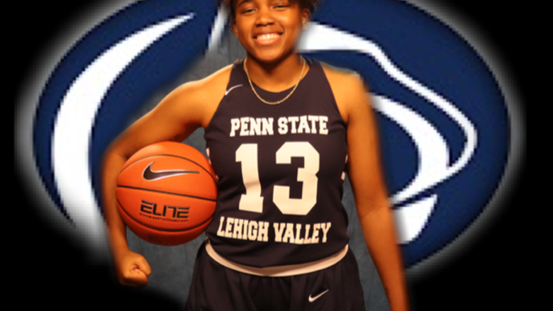 young woman smiling and holding basketball under arm