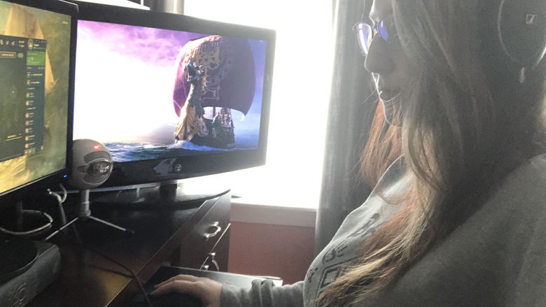 student looking at computer screen featuring video game