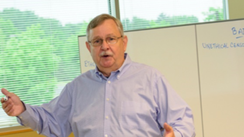 Kermit Burley in a classroom lecturing