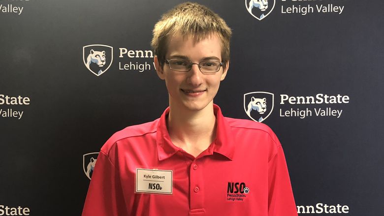 Young man standing in front of Penn State Lehigh Valley backdrop