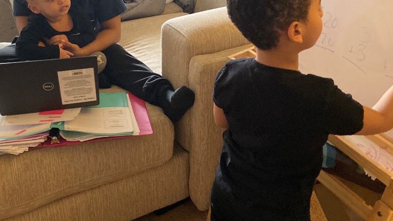 woman and her two kids at home near laptop