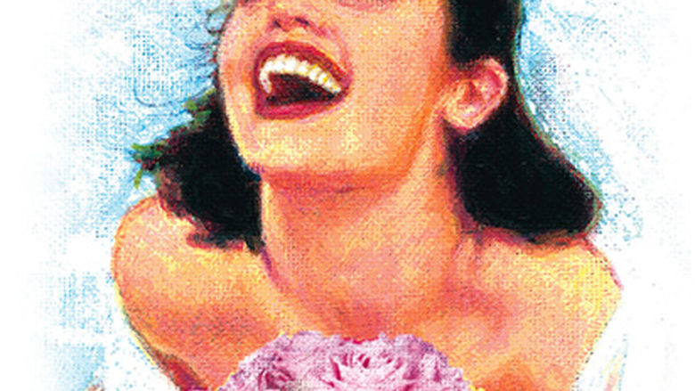 A bride laughing with her head thrown back, eyes closed, holding a bouquet of pink roses.