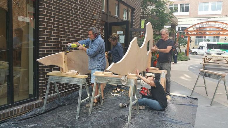people building trajectory heart sculpture