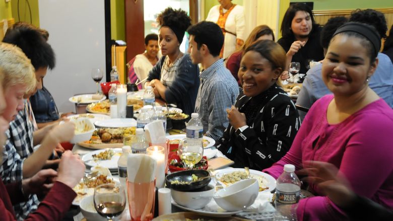 A group of students and alumni at dinner