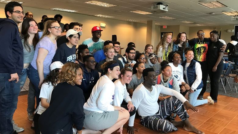 Group of African dancers with students