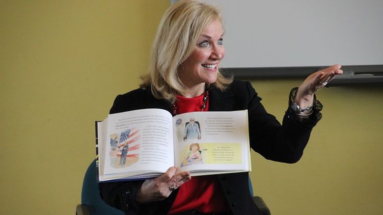 Woman reading a book at public event