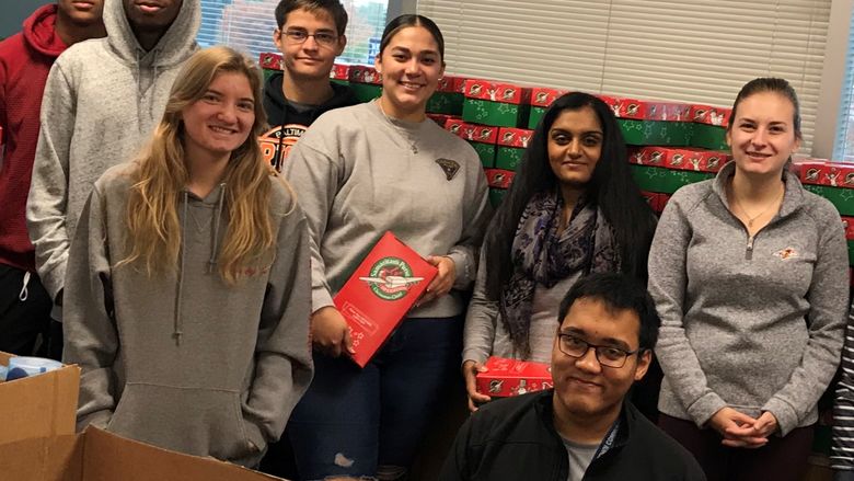 group of students near boxes