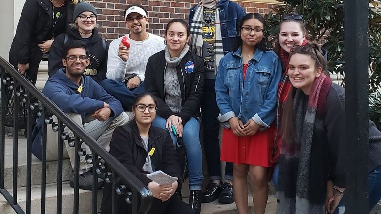 students and professor on steps outside of a museum