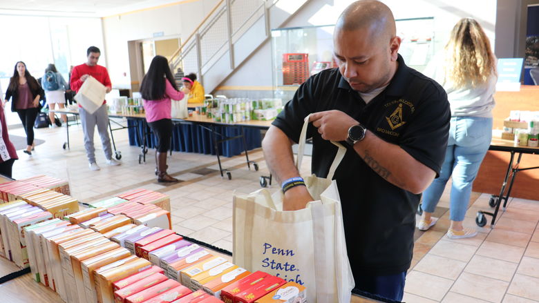 man filling bag with food