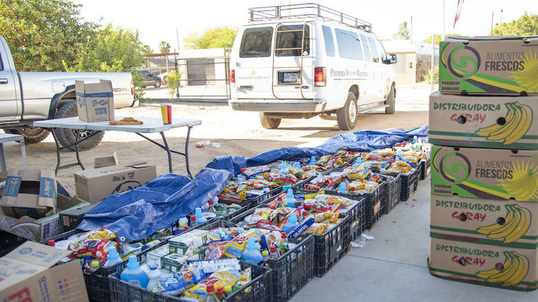 Photo of crates filled with food and cleaning supplies