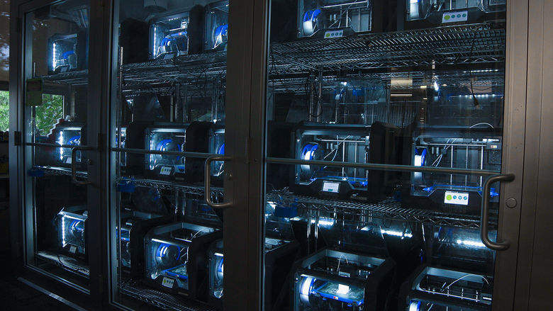 bank of 3D printers inside Maker Commons