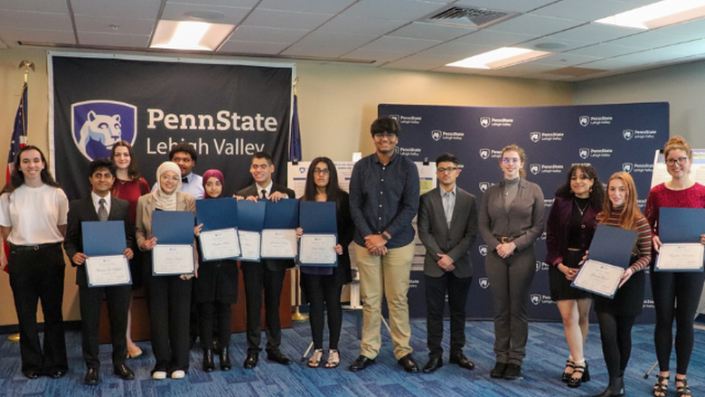 Students posing with awards