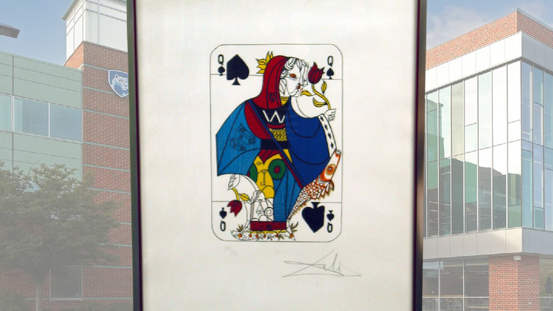 A framed photo of Salvadore Dali's piece, "Queen of Spades"