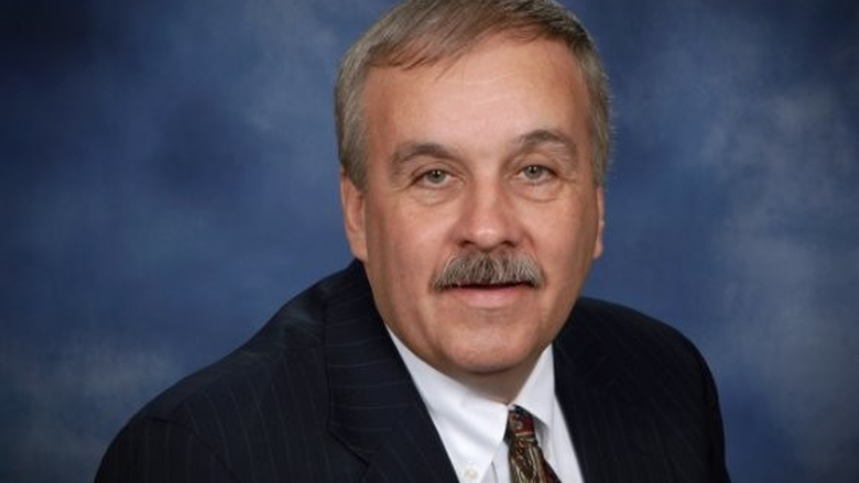 head shot of man in suit