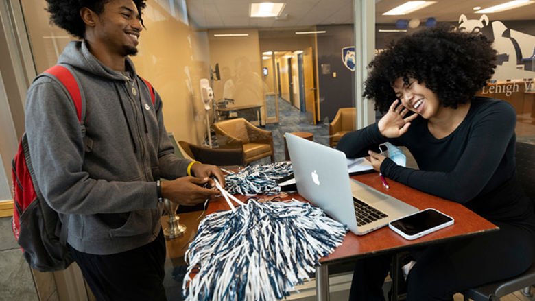 2 students laughing