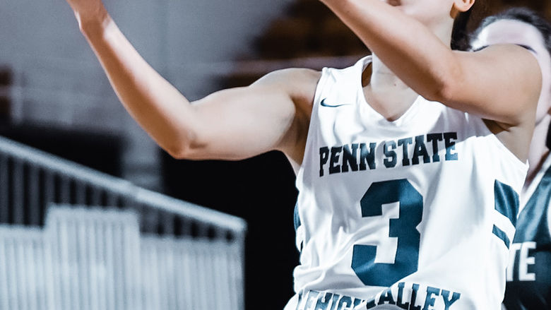 Female basketball player jumping with ball