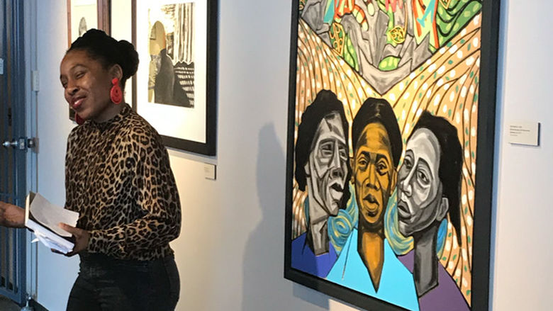 Artist speaking in gallery.