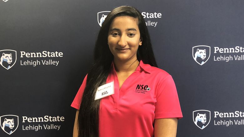Young woman standing in front of Penn State Lehigh Valley backdrop