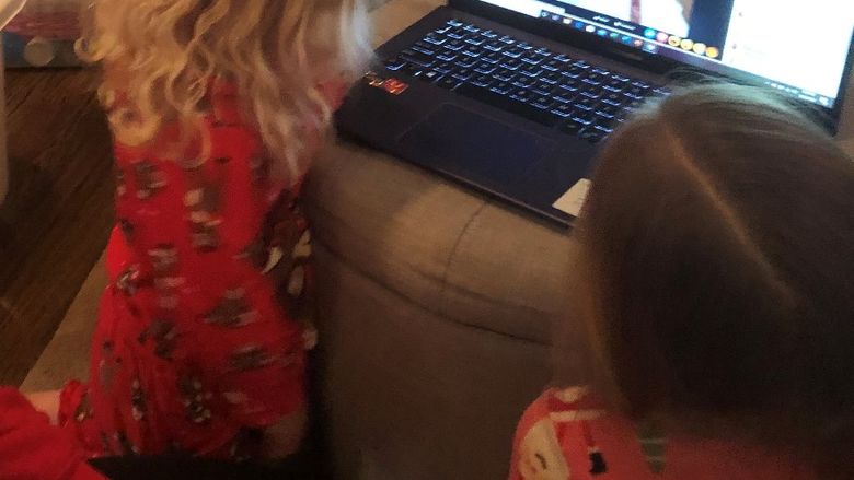 young kids looking at laptop