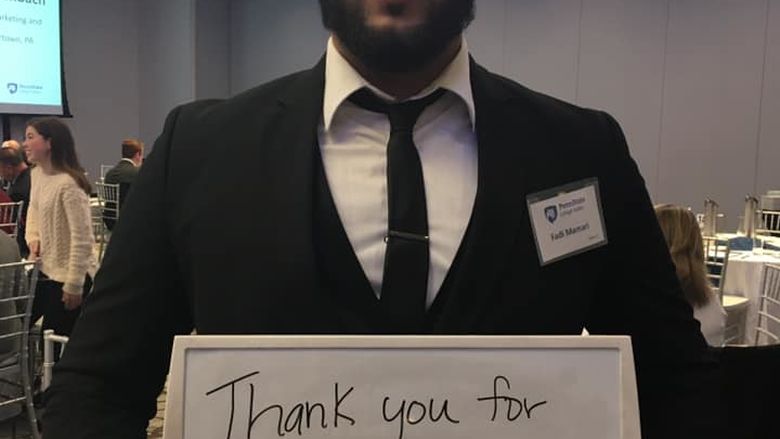 student holding marker board