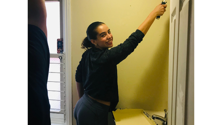 PSU-LV student paints a wall at Sixth Street Shelter, Allentown