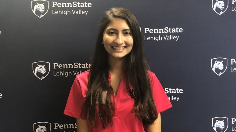 Young woman standing in front of Penn State Lehigh Valley backdrop