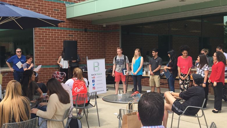 Students in the courtyard accepting awards
