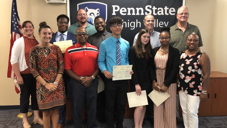 high school students and adults posing with certificate awards