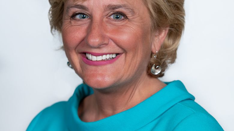 headshot of a woman in turquoise top