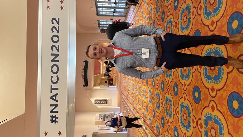 Trevor Faust standing at veterans conference 