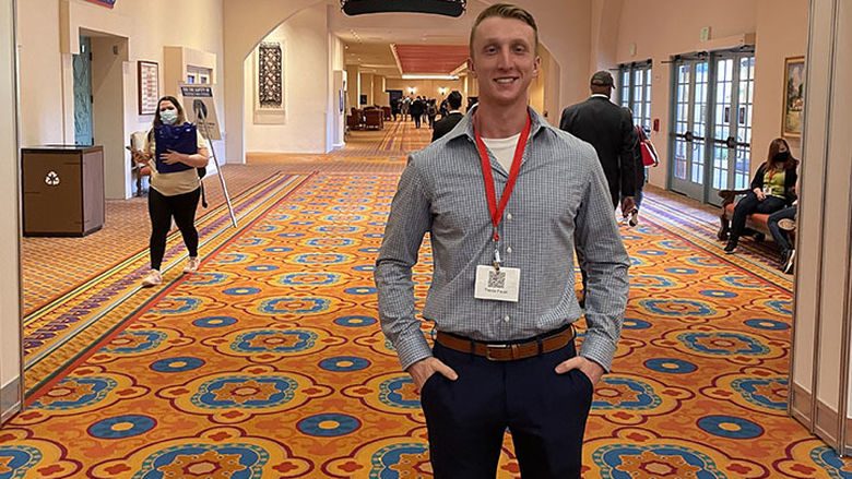 Trevor Faust stands at veterans conference 